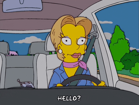 Woman driving, saying hello on phone.